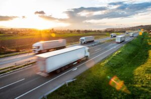 Semi trucks traveling on two sides of a freeway as the drivers try to avoid the 5 most common I-85 road hazards.