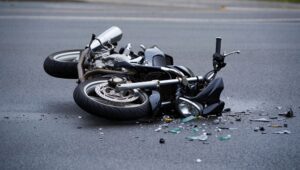 A crashed motorcycle on the street. What does a motorcycle accident lawyer do?