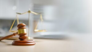 A gavel sitting on a table. Do personal injury cases settle after deposition?