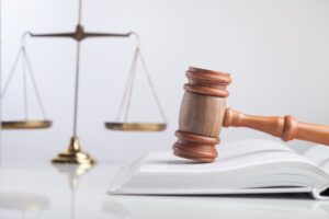 A gavel sitting on top of a law book. How long does a personal injury settlement take?