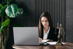A personal injury lawyer working at her desk. What does a personal injury lawyer do?